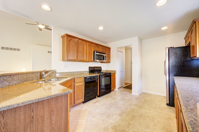 kitchen featuring black appliances, sink, ceiling fan, light stone counters, and kitchen peninsula