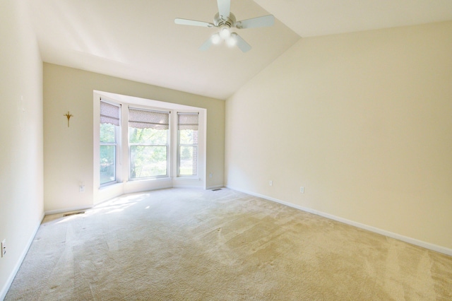 empty room with light carpet, ceiling fan, and lofted ceiling