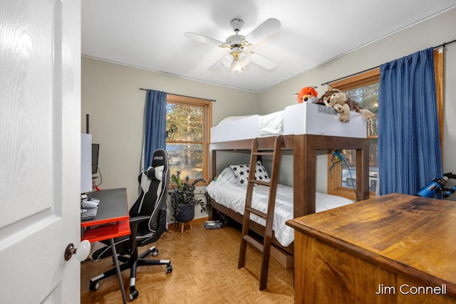 bedroom with light parquet floors and ceiling fan