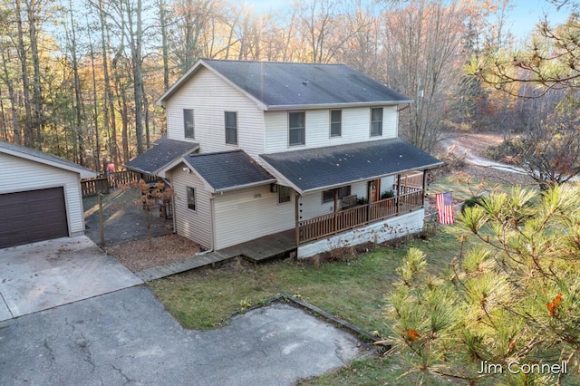 country-style home with an outbuilding, a garage, and covered porch