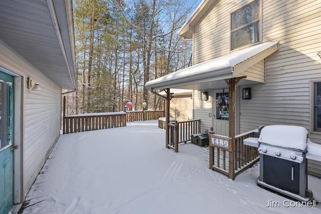 snow covered deck featuring grilling area