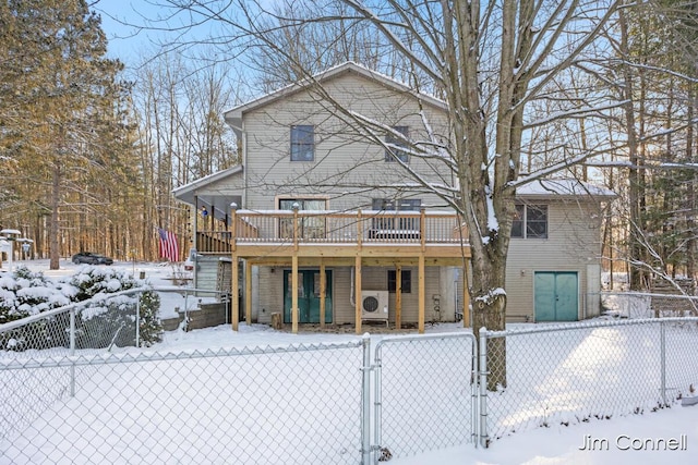 snow covered house with a deck