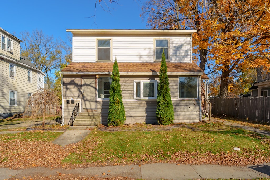 view of property featuring a front lawn