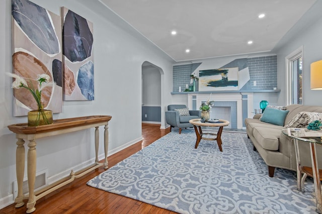 living room featuring a fireplace and hardwood / wood-style flooring