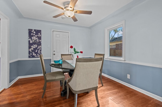 dining room with ceiling fan and hardwood / wood-style flooring