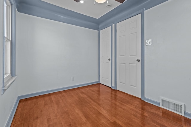 unfurnished bedroom featuring hardwood / wood-style floors and ceiling fan