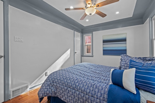 bedroom featuring hardwood / wood-style floors and ceiling fan