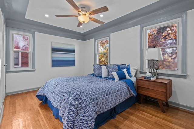 bedroom featuring hardwood / wood-style flooring and ceiling fan