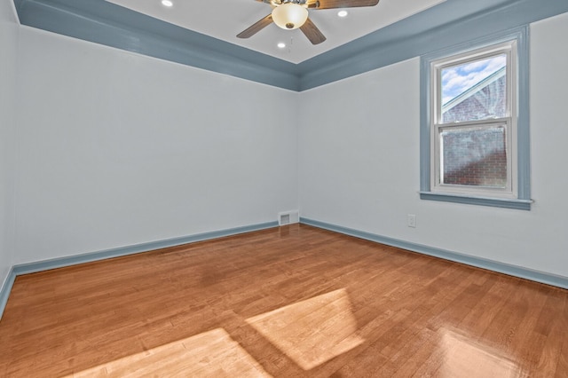 empty room featuring hardwood / wood-style flooring and ceiling fan