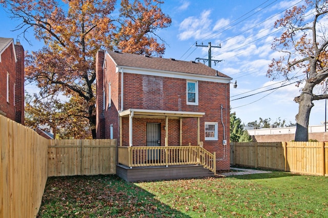 back of house with a yard