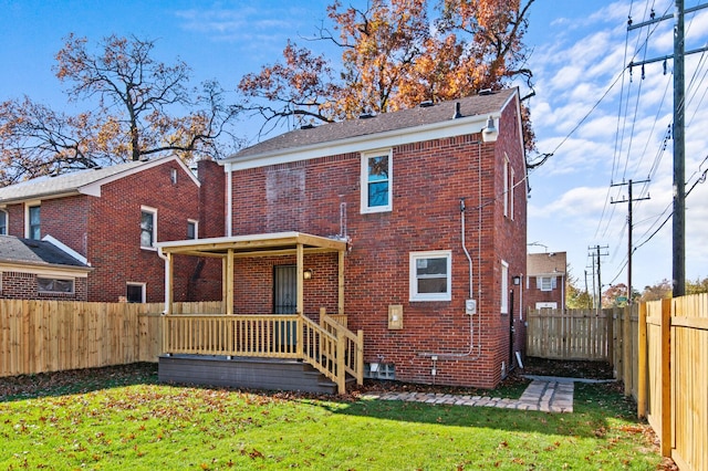 back of house with a lawn