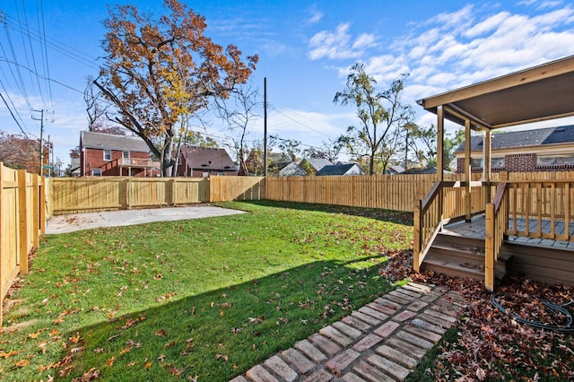 view of yard with a patio area and a wooden deck