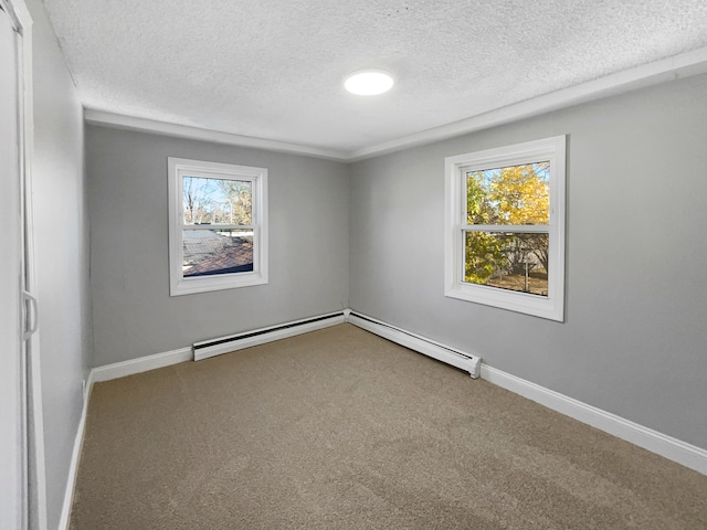 carpeted spare room with a textured ceiling and a baseboard radiator