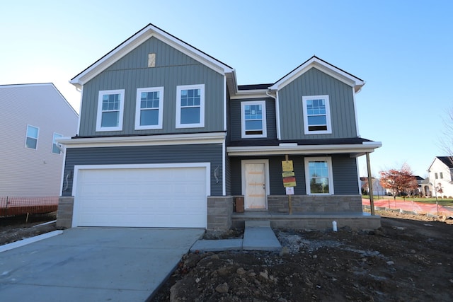 view of front of home featuring a porch and a garage