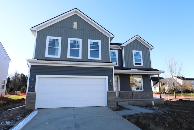 view of front of house with a porch and a garage