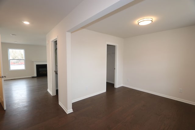 empty room with dark hardwood / wood-style flooring