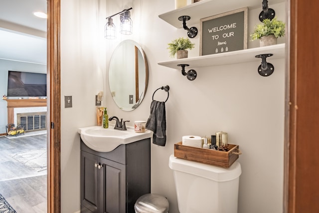 bathroom featuring hardwood / wood-style floors, vanity, and toilet