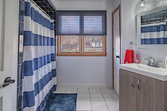 bathroom with tile patterned floors, vanity, and walk in shower