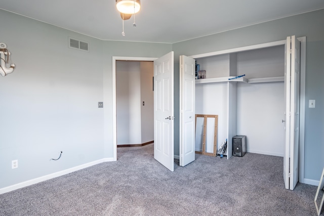 unfurnished bedroom with carpet flooring and a closet