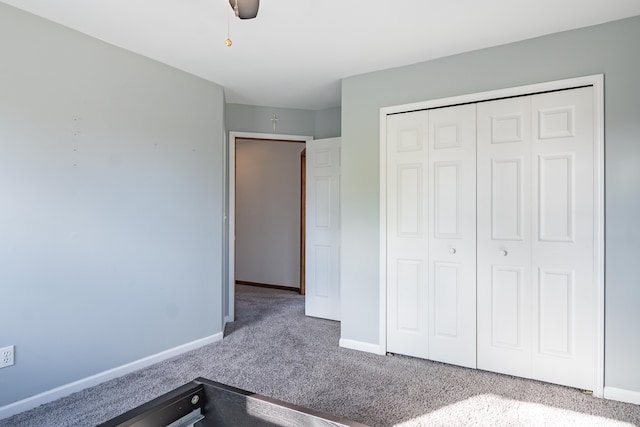 unfurnished bedroom with carpet flooring, a closet, and ceiling fan