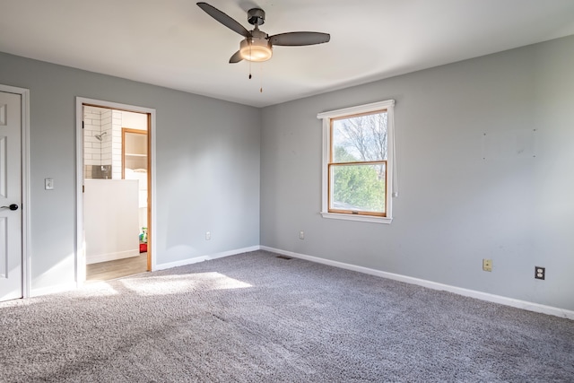 carpeted spare room with ceiling fan