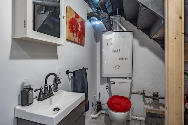 bathroom featuring tile patterned floors, vanity, and toilet