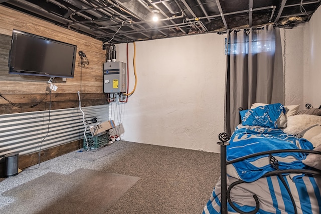 basement with carpet floors, wooden walls, and water heater