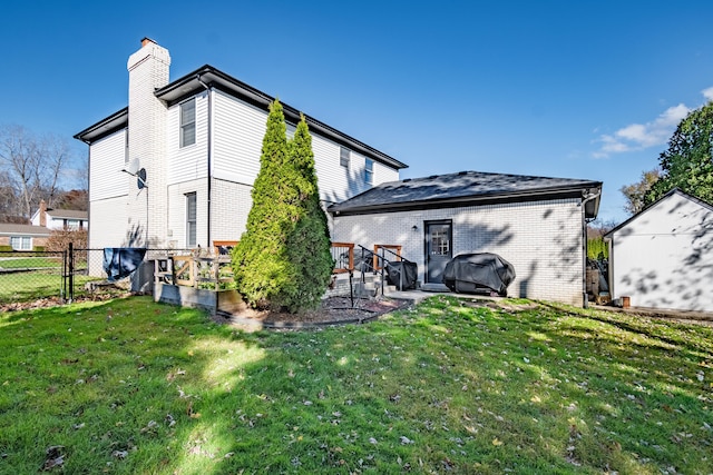 back of house with a yard and a wooden deck