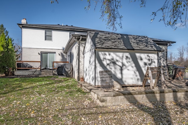 back of house featuring a yard and a wooden deck