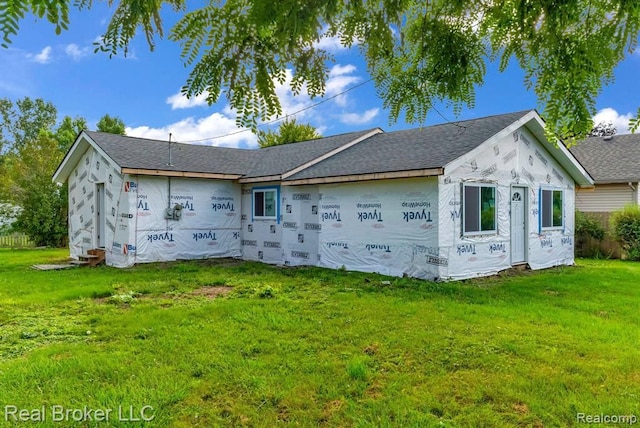 rear view of property with a lawn