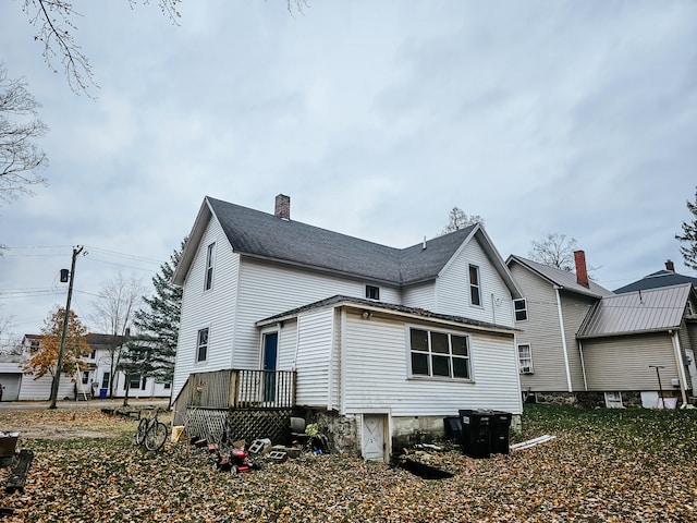 back of house with a wooden deck