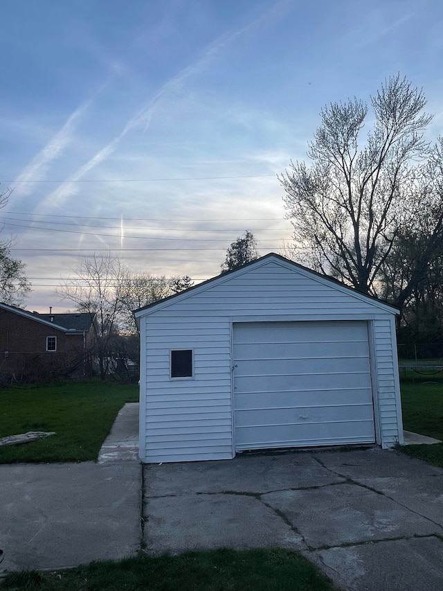 view of garage at dusk