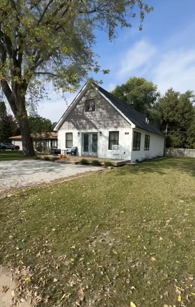 view of side of home with a yard