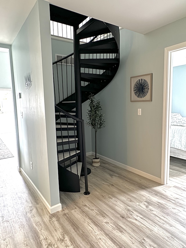 staircase with hardwood / wood-style floors