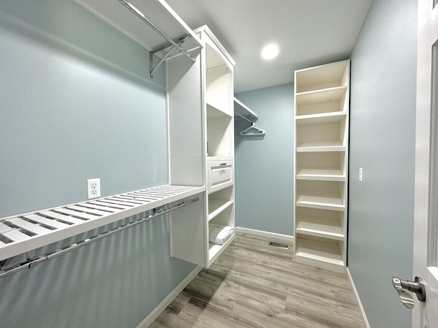 spacious closet featuring light hardwood / wood-style flooring