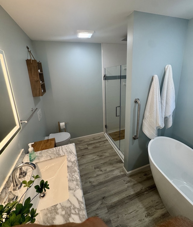 bathroom featuring hardwood / wood-style floors, vanity, and independent shower and bath