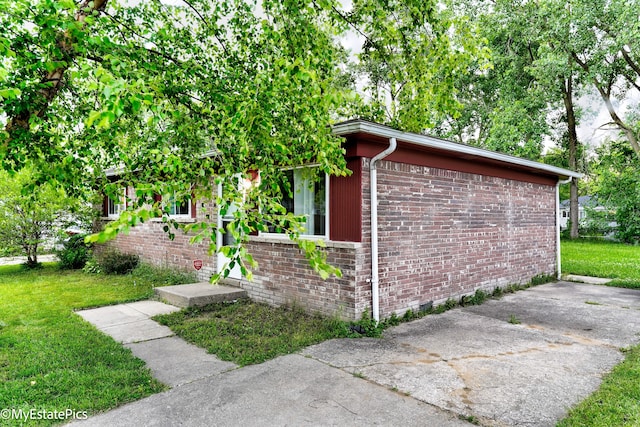 view of side of home with a yard