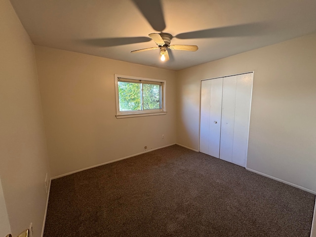 unfurnished bedroom with ceiling fan, a closet, and carpet