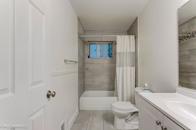 full bathroom featuring tile patterned flooring, vanity, shower / bath combo, and toilet