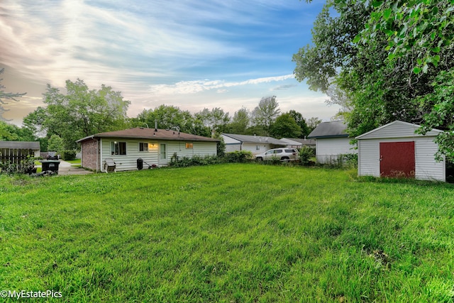 yard at dusk featuring a storage unit