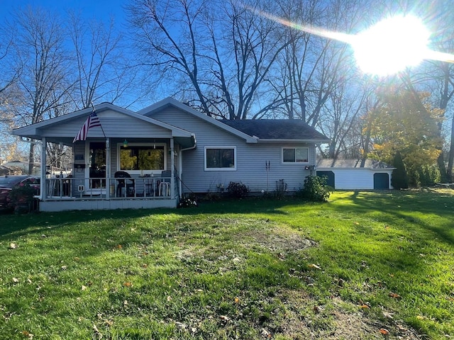 rear view of property with a porch and a yard