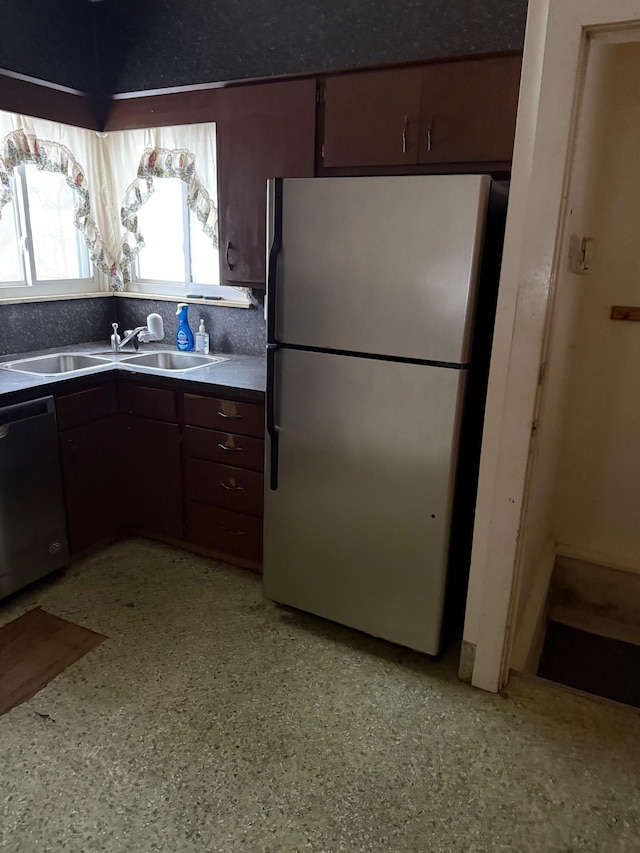 kitchen with sink, dark brown cabinets, and appliances with stainless steel finishes