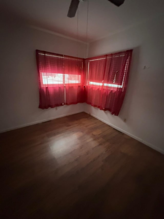 empty room with ceiling fan and hardwood / wood-style floors