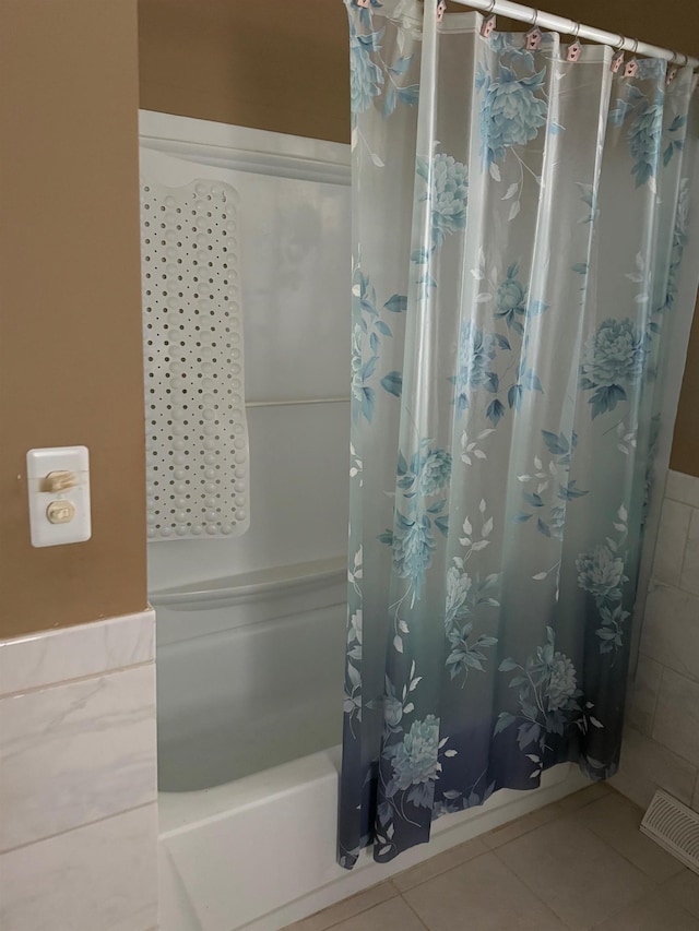 bathroom featuring tile patterned floors and shower / bath combo