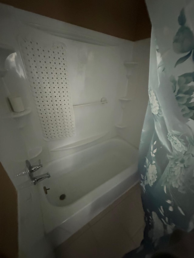 bathroom featuring tile patterned floors and shower / bathtub combination with curtain