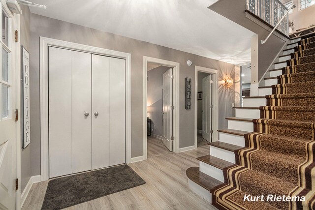 3205 Lakeshore Dr, Saint Joseph, MI 49085 - foyer featuring stairway, light wood-style flooring, and baseboards