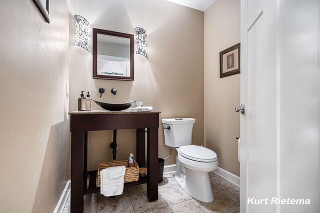 3205 Lakeshore Dr, Saint Joseph, MI 49085 - bathroom featuring toilet, a sink, and baseboards