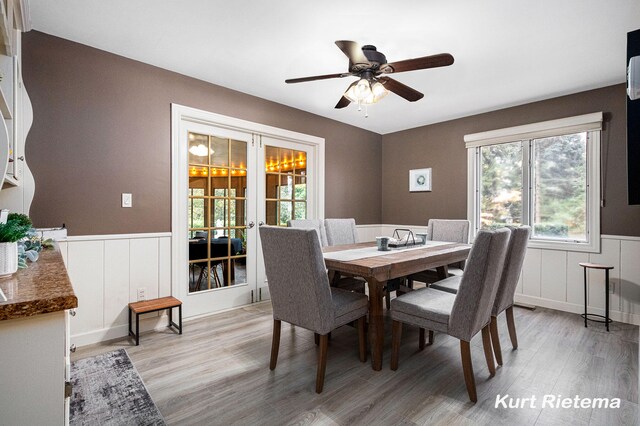3205 Lakeshore Dr, Saint Joseph, MI 49085 - dining space featuring french doors, light wood-type flooring, plenty of natural light, wainscoting, and ceiling fan