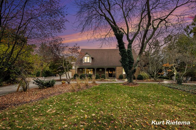 3205 Lakeshore Dr, Saint Joseph, MI 49085 - new england style home featuring a front yard and driveway