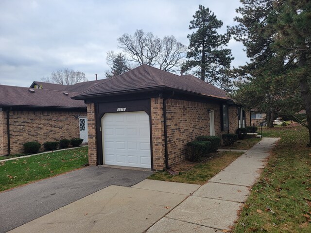 view of side of property featuring a yard and a garage